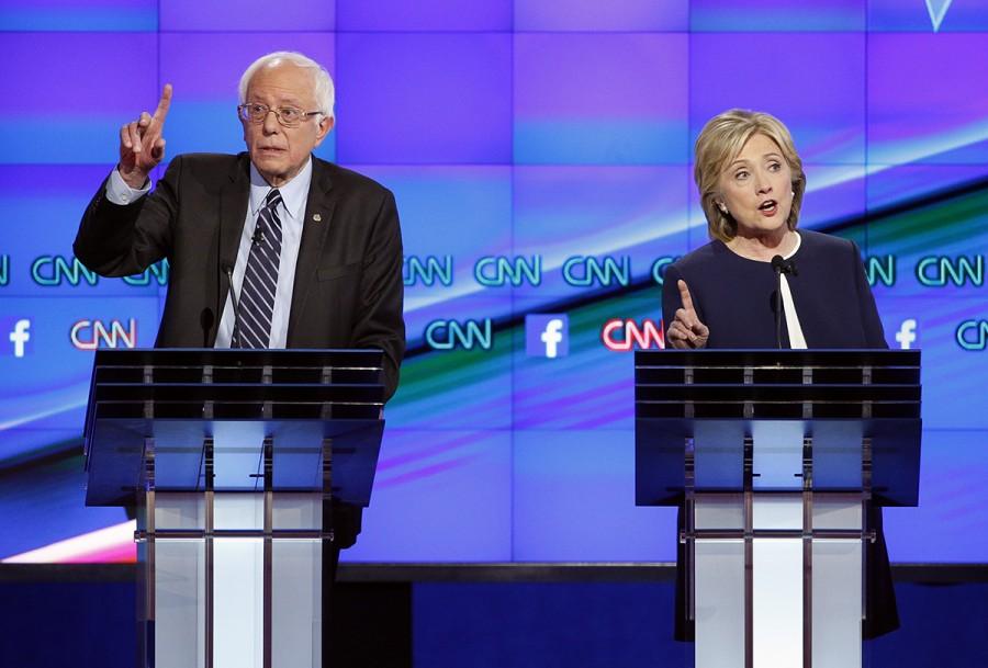 Hillary Rodham Clinton, right, and Sen. Bernie Sanders, of Vermont, speak during the CNN Democratic presidential debate Tuesday, Oct. 13, 2015, in Las Vegas. (AP Photo/John Locher)