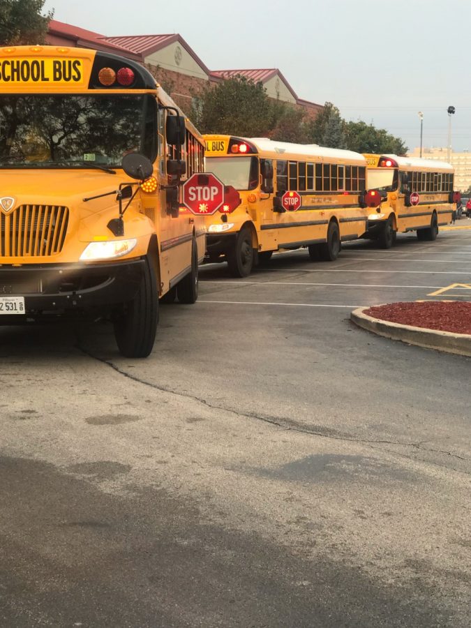 Buses lined up to drop students off in front of Joliet West High School show the new stop arms. Photo courtesy of Ms. Galloy. 