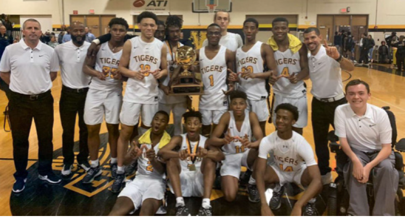 Joliet West varsity basketball team taking pictures together after winning 1st place in this year’s basketball Thanksgiving tournament. Photo courtesy of Steve Millsaps.