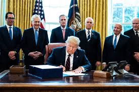 President Donald Trump signed the CARES Act into law on March 27. This Act includes $2 trillion to be distributed among families and businesses, making it the largest stimulus plan in US history. Photo courtesy of CNBC.