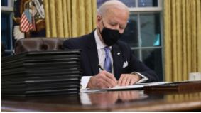 President Biden signs the first of many executive orders.
